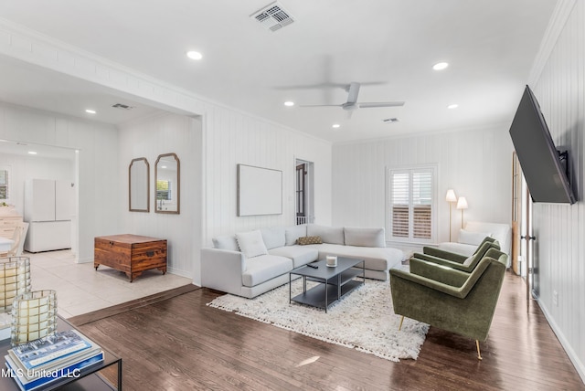 living room with ceiling fan, ornamental molding, and hardwood / wood-style flooring