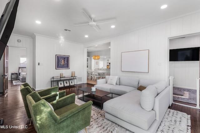 living room with crown molding, hardwood / wood-style floors, and ceiling fan