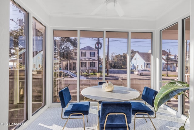 sunroom with ceiling fan and a healthy amount of sunlight