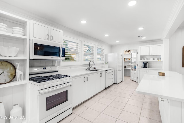 kitchen with white appliances, white cabinets, sink, light tile patterned floors, and ornamental molding