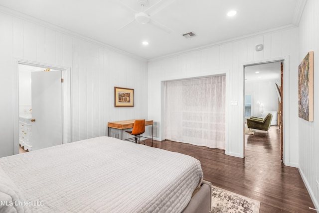 bedroom with ceiling fan, dark hardwood / wood-style flooring, wood walls, and ornamental molding