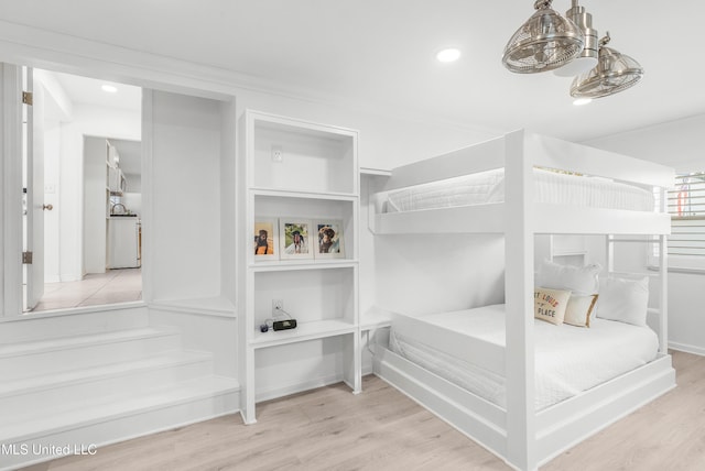 bedroom featuring washer / dryer and light hardwood / wood-style flooring