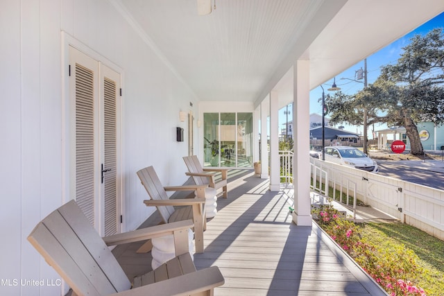 wooden terrace featuring covered porch