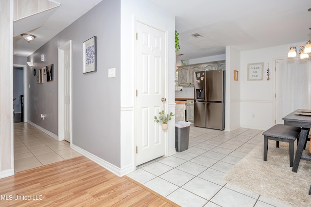 hallway featuring light tile patterned floors