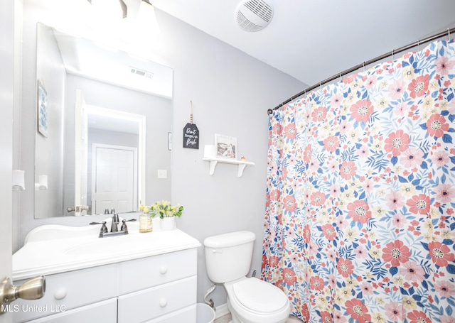 bathroom with vanity, toilet, and walk in shower