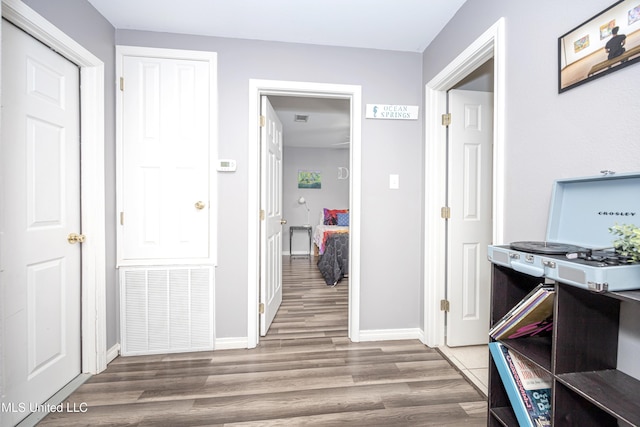 corridor featuring hardwood / wood-style floors