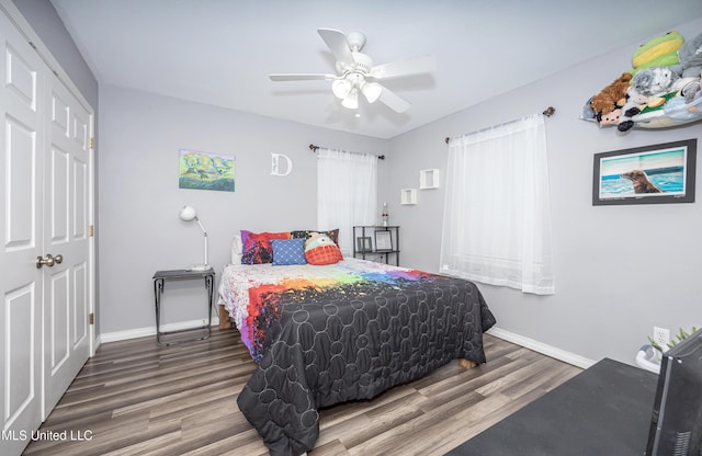 bedroom with hardwood / wood-style floors, ceiling fan, and a closet