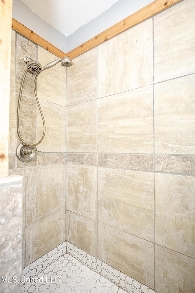 bathroom with tiled shower