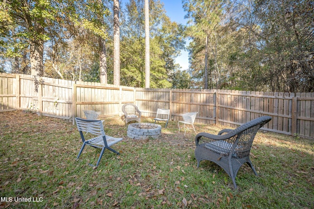 view of yard with a fire pit