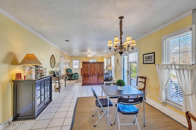 dining area featuring light tile patterned floors, a healthy amount of sunlight, crown molding, and a textured ceiling