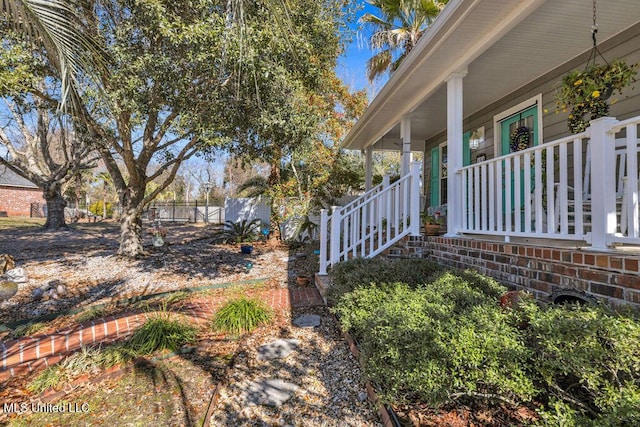 view of yard featuring covered porch