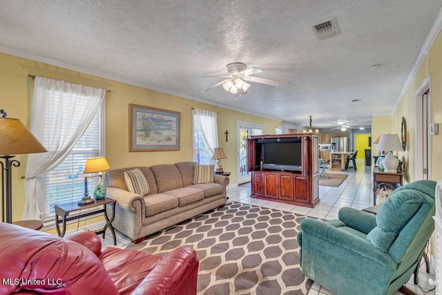 tiled living room featuring ceiling fan, a wealth of natural light, a textured ceiling, and crown molding