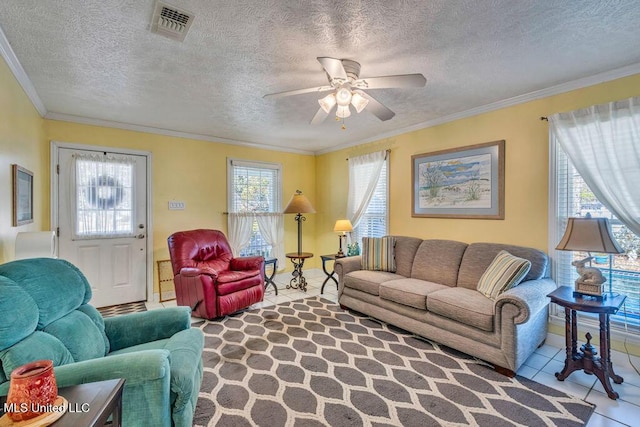 living room featuring ceiling fan, a textured ceiling, tile patterned floors, and crown molding