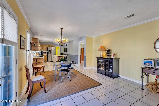 tiled dining area featuring ornamental molding and an inviting chandelier