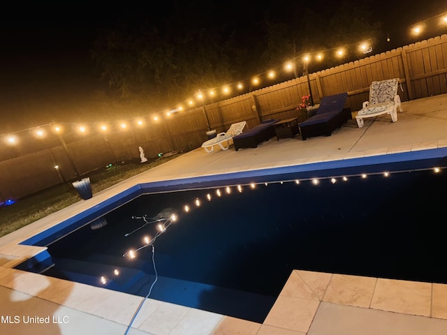 6509 Sugarcane Cir, Ocean Springs, MS 39564 - pool at night with fence, a patio area, and a fenced in pool