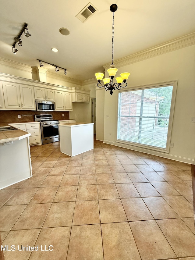 302 Bedford Ct, Brandon, MS 39047 - kitchen with appliances with stainless steel finishes, crown molding, track lighting, a chandelier, and light tile patterned floors