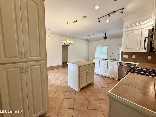 302 Bedford Ct, Brandon, MS 39047 - kitchen with a sink, appliances with stainless steel finishes, ceiling fan, light tile patterned floors, and a chandelier