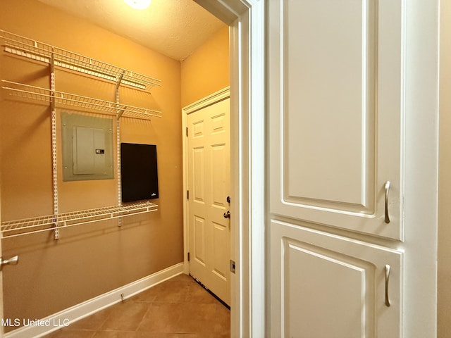 302 Bedford Ct, Brandon, MS 39047 - doorway to outside featuring electric panel, tile patterned floors, and baseboards