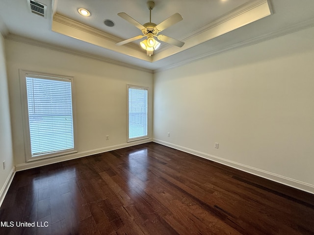 302 Bedford Ct, Brandon, MS 39047 - empty room featuring a raised ceiling, dark wood-style floors, ornamental molding, plenty of natural light, and ceiling fan