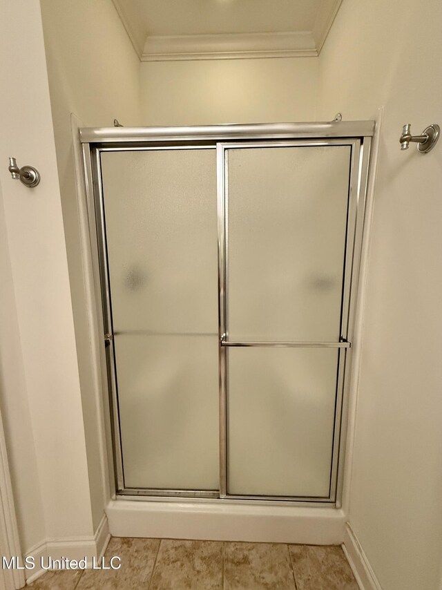 302 Bedford Ct, Brandon, MS 39047 - full bathroom with ornamental molding, an enclosed shower, baseboards, and tile patterned floors