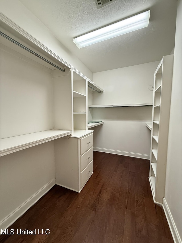 302 Bedford Ct, Brandon, MS 39047 - spacious closet featuring dark wood-style flooring and built in desk