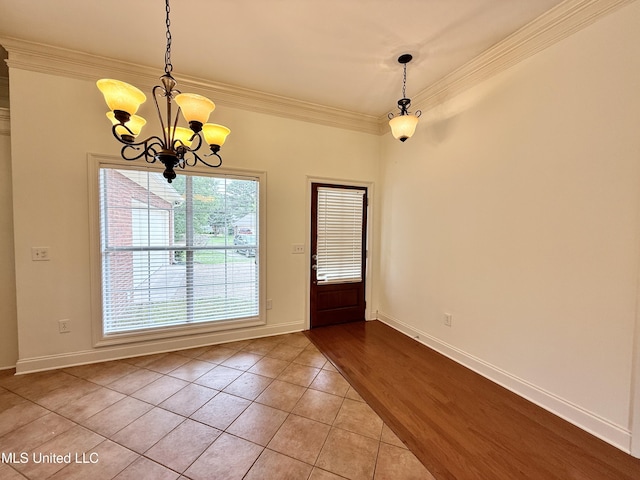 302 Bedford Ct, Brandon, MS 39047 - unfurnished dining area featuring a chandelier, crown molding, light tile patterned floors, and baseboards