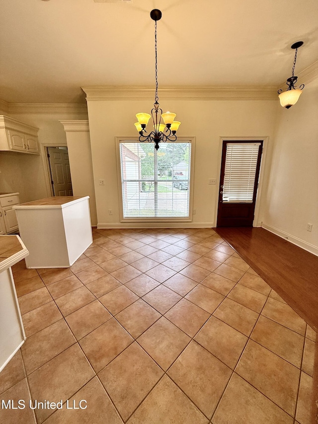 302 Bedford Ct, Brandon, MS 39047 - unfurnished dining area with light tile patterned floors, ornamental molding, a chandelier, and baseboards