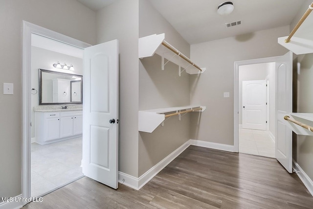 spacious closet featuring hardwood / wood-style floors