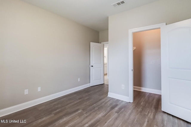 unfurnished bedroom featuring dark hardwood / wood-style floors