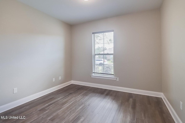 empty room featuring dark hardwood / wood-style flooring