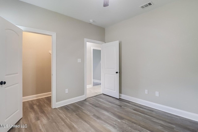 unfurnished bedroom with wood-type flooring and ceiling fan