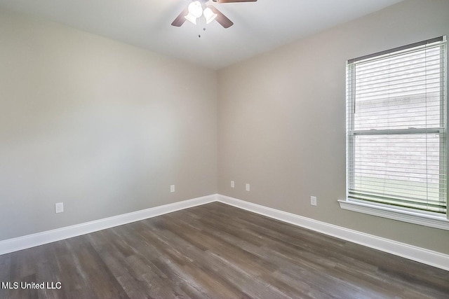 spare room with dark hardwood / wood-style flooring and ceiling fan