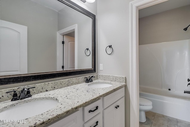 full bathroom featuring tile patterned flooring, vanity, toilet, and washtub / shower combination