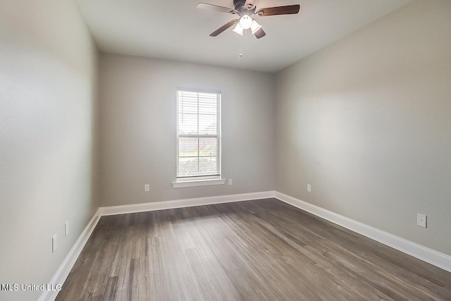 spare room with ceiling fan and dark hardwood / wood-style flooring