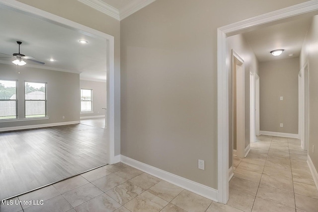 corridor featuring light tile patterned floors and ornamental molding