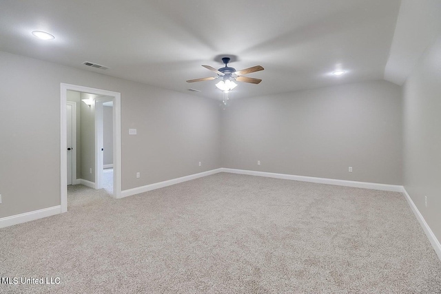 spare room with light carpet, ceiling fan, and lofted ceiling