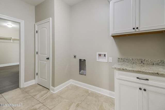 clothes washing area featuring cabinets, washer hookup, and electric dryer hookup