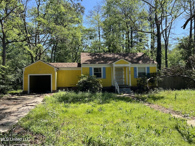 1918 E Dr, Jackson, MS 39204 - single story home with board and batten siding, driveway, a shingled roof, and a garage