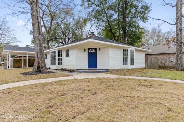 ranch-style house with a front lawn, a chimney, fence, and an attached carport