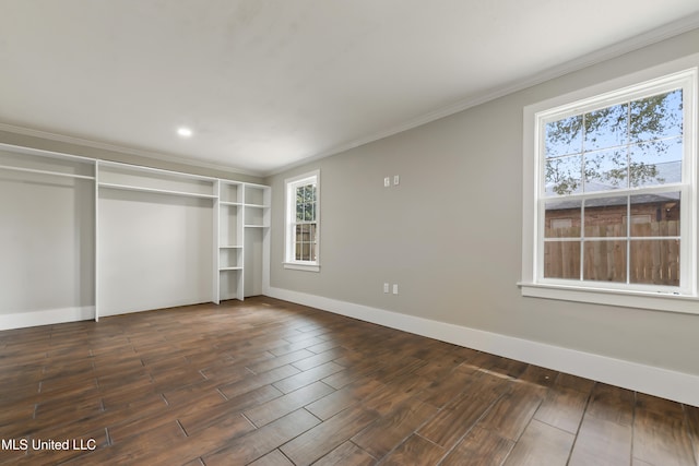 unfurnished bedroom featuring ornamental molding, dark wood-style flooring, and baseboards