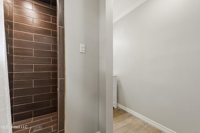 bathroom featuring wood finished floors and baseboards