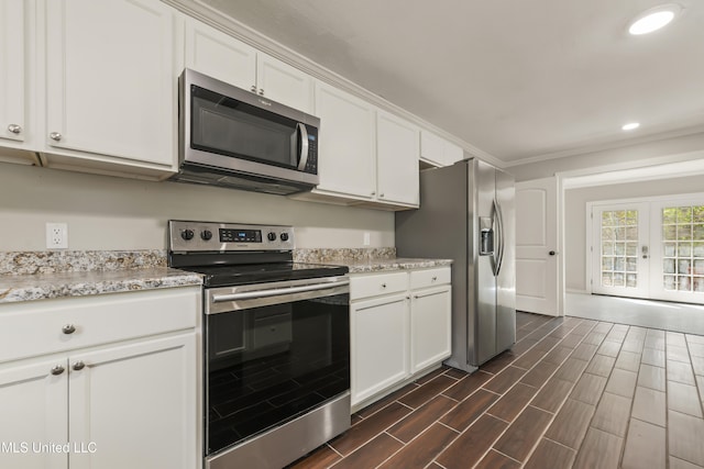 kitchen featuring recessed lighting, wood finish floors, white cabinets, french doors, and appliances with stainless steel finishes