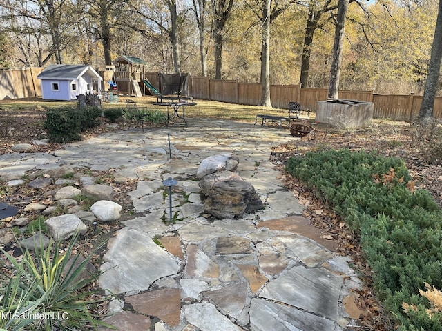 5 Lombardy Rd, Drew, MS 38737 - view of yard featuring a shed, a patio, a playground, and an outdoor fire pit