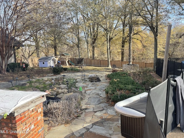 5 Lombardy Rd, Drew, MS 38737 - view of yard with a shed, a patio area, and a playground