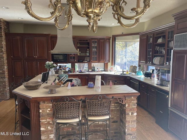 5 Lombardy Rd, Drew, MS 38737 - kitchen with black microwave, light hardwood / wood-style flooring, dark brown cabinets, and a textured ceiling