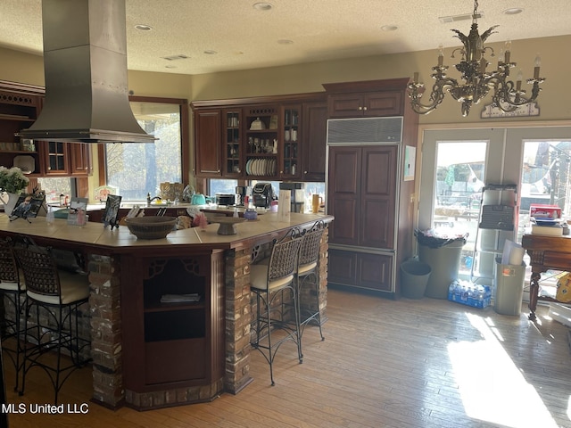 5 Lombardy Rd, Drew, MS 38737 - kitchen with a wealth of natural light, a breakfast bar, island range hood, and light hardwood / wood-style flooring