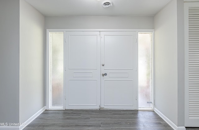 unfurnished bedroom with a closet and dark wood-type flooring