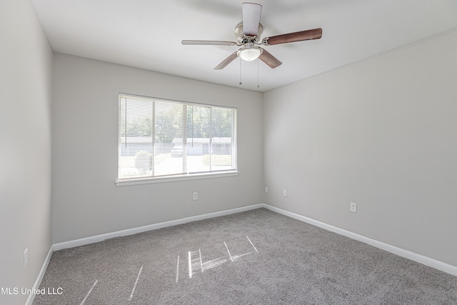 carpeted spare room featuring ceiling fan