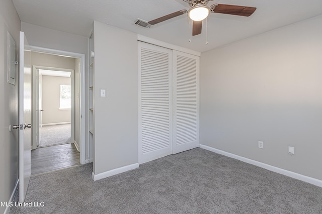 unfurnished bedroom with ceiling fan, a closet, and light carpet