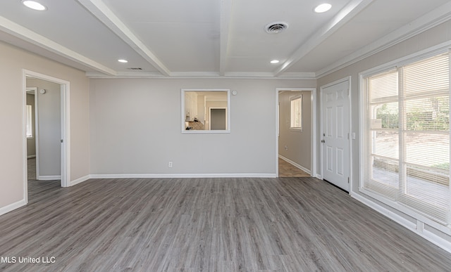 unfurnished room featuring hardwood / wood-style floors, beam ceiling, and crown molding